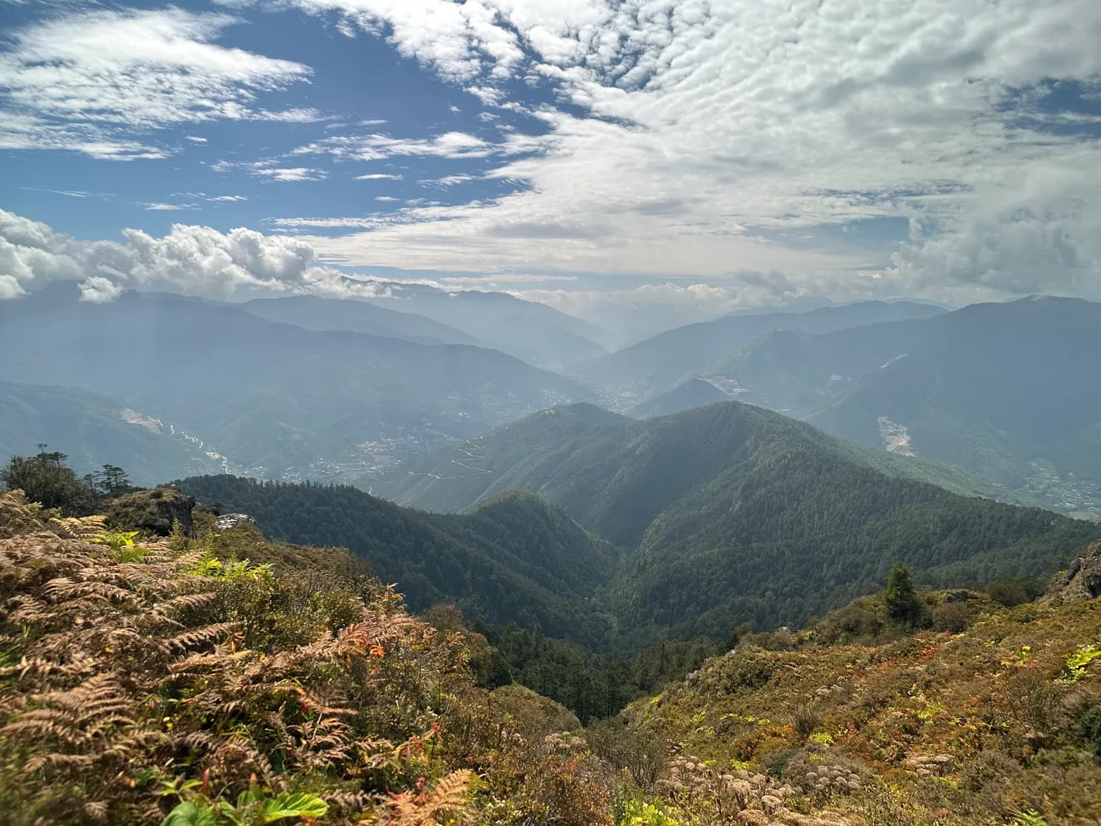 Layer on layer of forested Himalayan ridgelines fading into haze