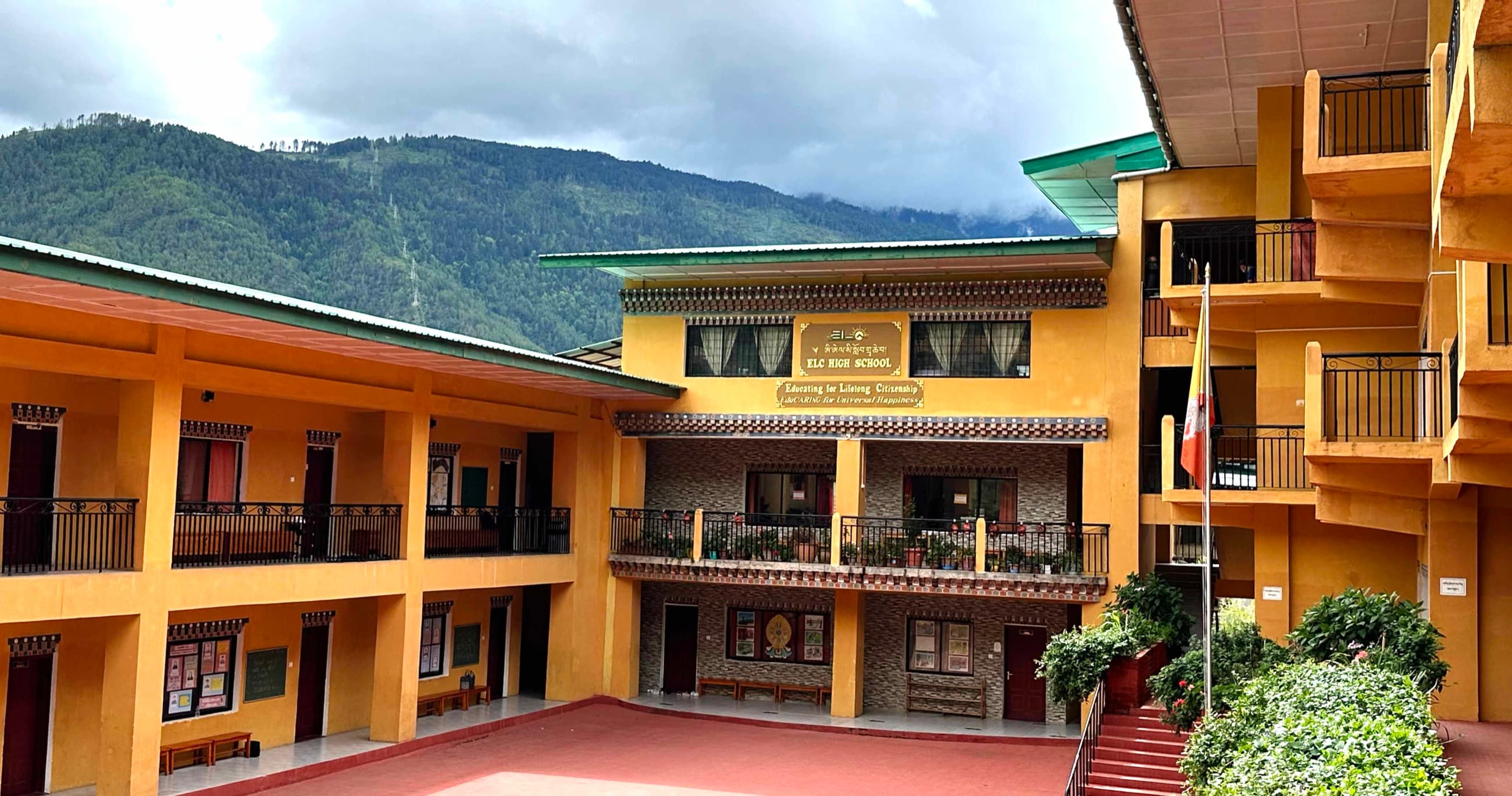 The ELC High School courtyard, with the forested hills above Thimphu beyond