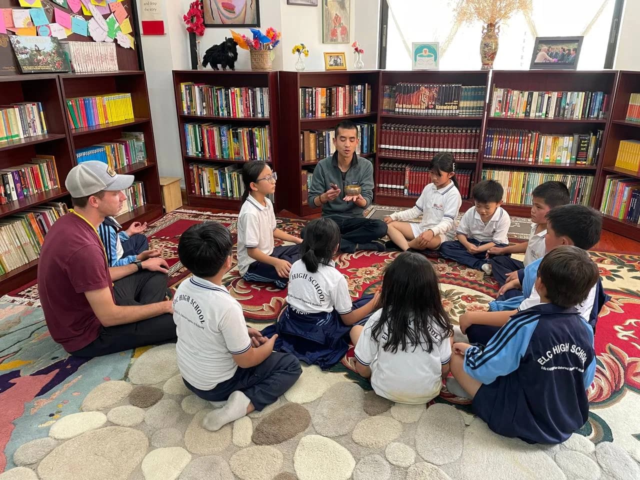 An ELC classroom during a mindful moment, students seated with eyes closed